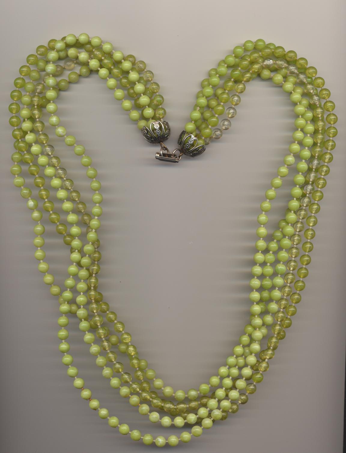 Vintage multi strand plastic imitation bead necklace made in different hues of green, with clasp, 1960's, length 25'' 64cm.