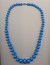 Graduated bright blue plastic imitation bead necklace, with clasp, 1970's, length 24'' 60cm.
